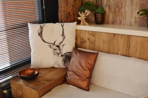 Warm rustic interior with wooden walls and white and copper accent pieces